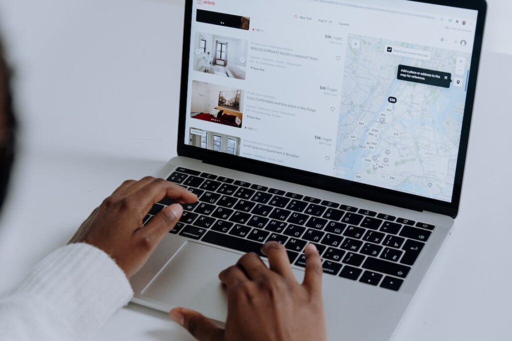 A laptop with the Airbnb booking platform on screen