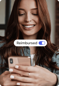 Image of a woman looking at her phone and smiling. She opens her Truvi platform Incident resolution services tab and sees that her damages have been reimbursed.