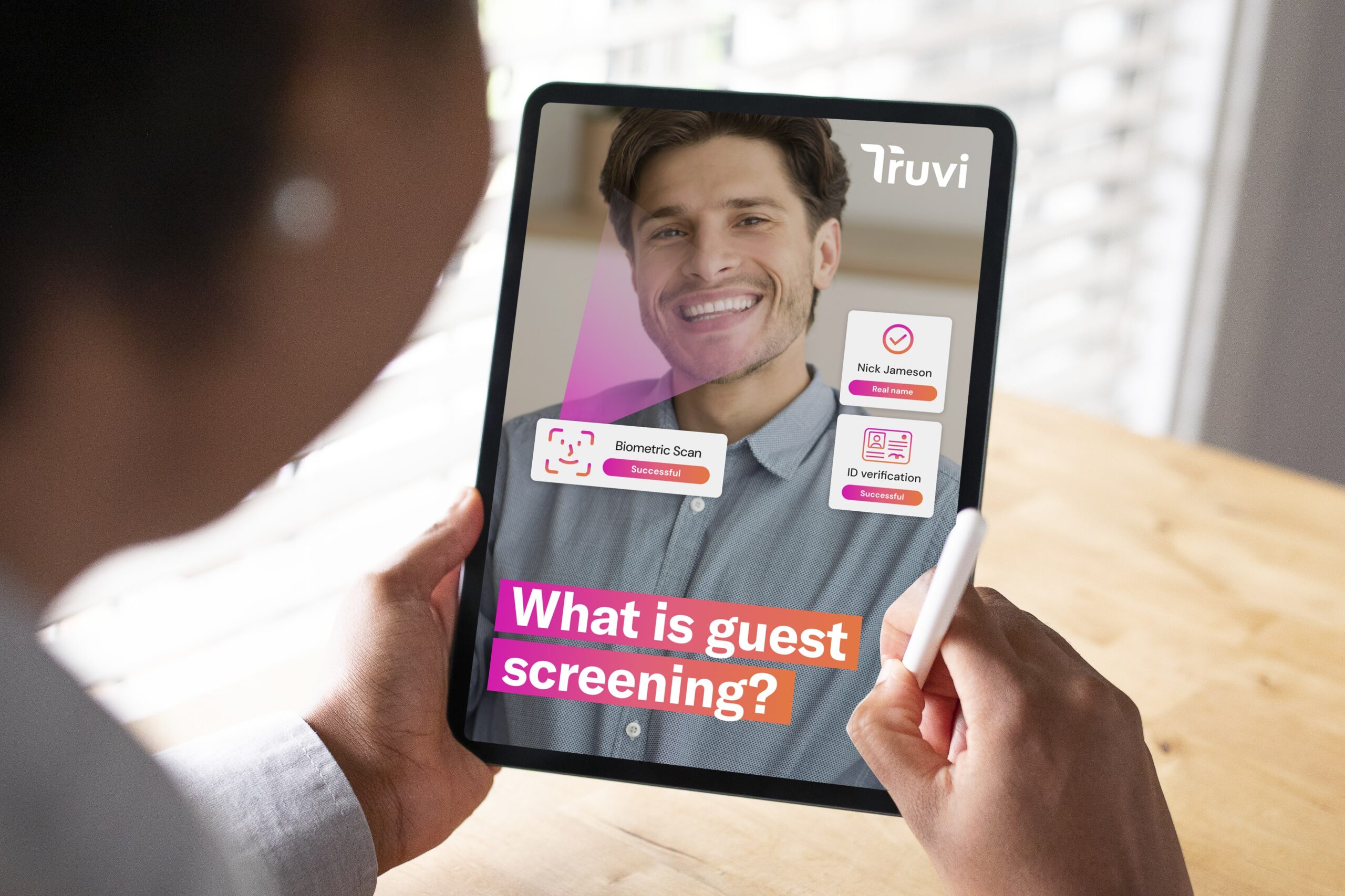 A woman holding a tablet with an image titled "Guest screening guide".